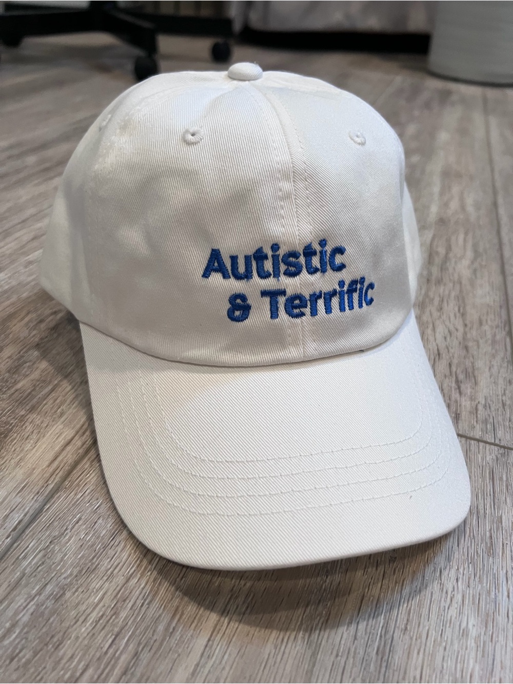 White Baseball Cap with Blue "Autistic & Terrific" Embroidery